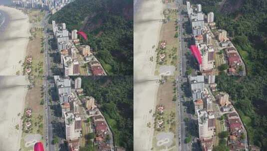 滑翔伞飞过海岸城市高清在线视频素材下载