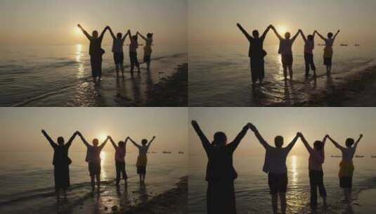 唯美海边日出日落夕阳拍照的游客高清在线视频素材下载