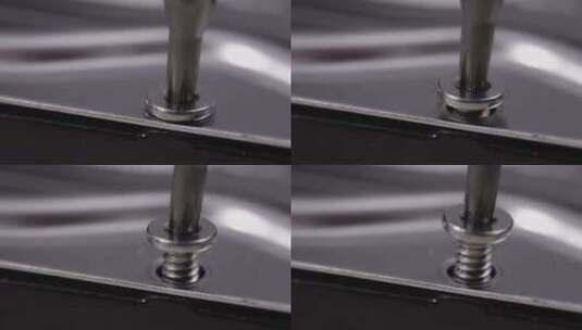 用螺丝刀拆卸金属设备上的螺丝特写高清在线视频素材下载