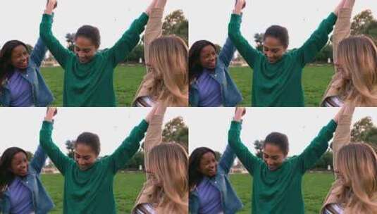 三个多种族女性朋友在户外举手庆祝高清在线视频素材下载