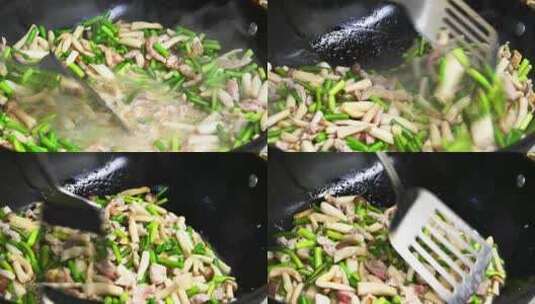 家常菜制作蒜苔炒肉丝锅中冒热气特写高清在线视频素材下载