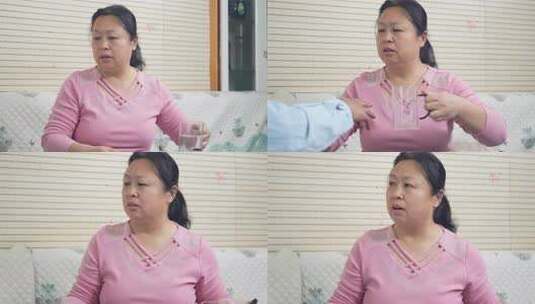 中年女性沙发手持水杯高清在线视频素材下载