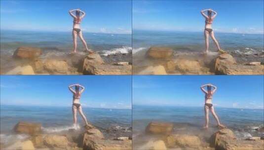 美女站在海浪拍打的海岸上高清在线视频素材下载