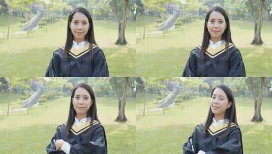女毕业生站在草地上微笑高清在线视频素材下载