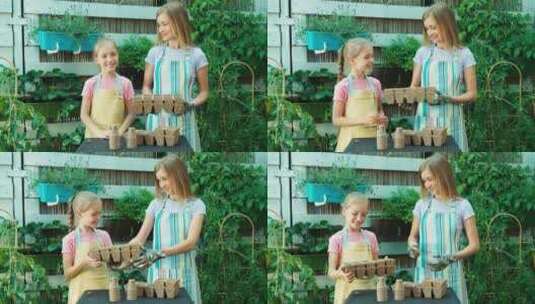 母亲和女儿在户外抱着泥炭罐高清在线视频素材下载