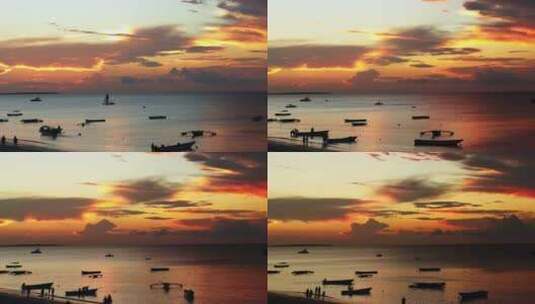时光流逝——坦桑尼亚桑给巴尔努格威海滩上美丽的日落和船只高清在线视频素材下载