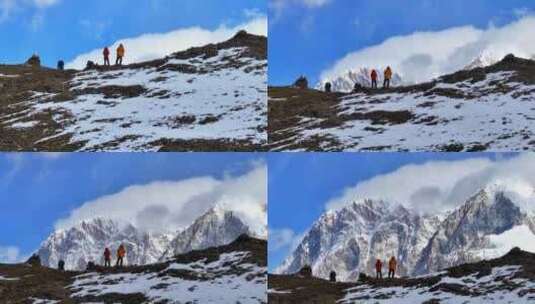 航拍垭口观看贡嘎山区雪山群峰的徒步旅行者高清在线视频素材下载