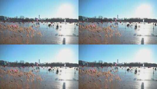 北京冬季阳光下朝阳公园冰场滑冰的人群高清在线视频素材下载
