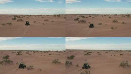 人们在沙漠空中驾驶着挂着赛车旗的童车高清在线视频素材下载
