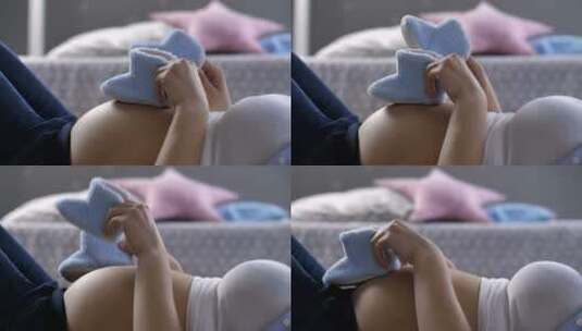 孕妇玩婴儿鞋高清在线视频素材下载