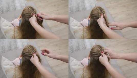 剪裁的手母亲编织的女儿头发，慢动作高清在线视频素材下载