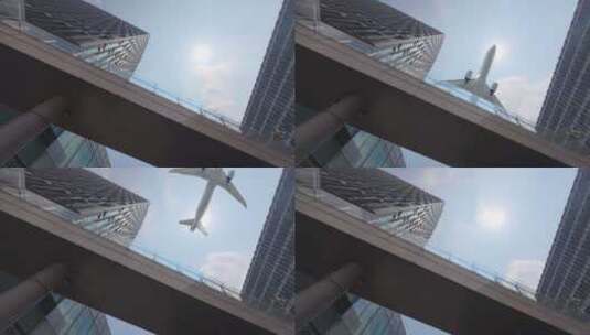 飞机在摩天大楼大厦上空飞行高清在线视频素材下载