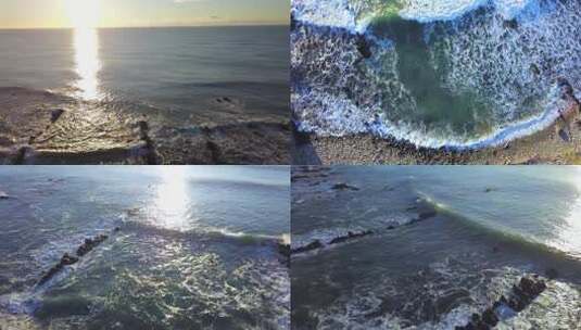 航拍大海海浪拍打礁石太阳光线照射在海面上高清在线视频素材下载