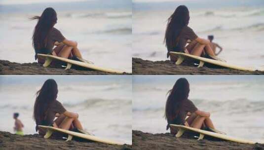4K-冲浪美女坐在海滩上的空镜头高清在线视频素材下载