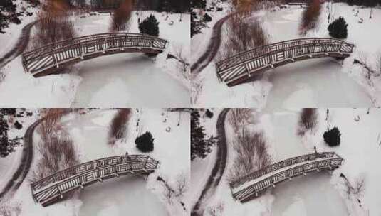 航拍公园被冰雪覆盖的小溪和桥梁高清在线视频素材下载