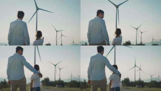 爸爸陪女儿看风力发电风车高清在线视频素材下载
