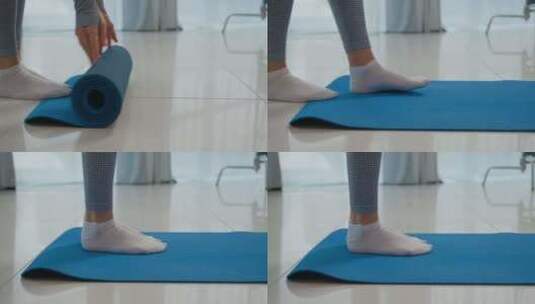 特写腿女人在地板上滚动体操垫瑜伽训练认不高清在线视频素材下载