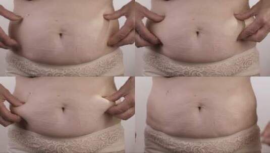 肥胖的女人触摸她的胃高清在线视频素材下载