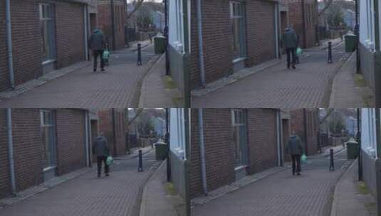 老人走在巷子里的手持宽镜头高清在线视频素材下载