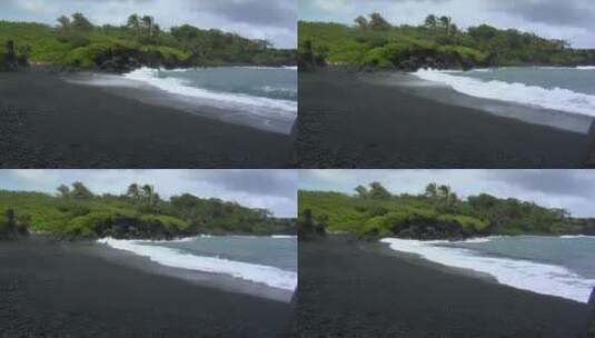 海浪冲击夏威夷的黑色沙滩高清在线视频素材下载