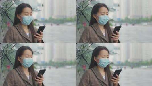中国女性打伞步行踏春打电话等公交玩手机高清在线视频素材下载