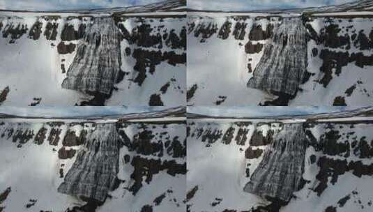航拍悬崖边上被大雪覆盖的瀑布高清在线视频素材下载