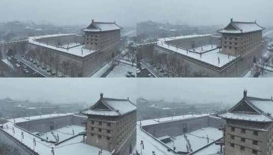 航拍陕西省西安市大雪中的西安安远门古城墙高清在线视频素材下载