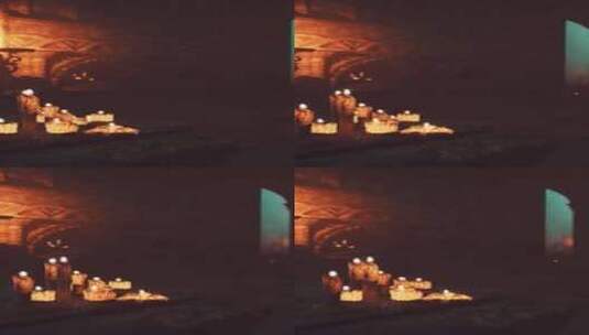 一组点燃的蜡烛照亮寺庙中的黑暗房间高清在线视频素材下载