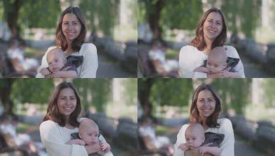 美丽的母亲微笑着，在夏天把她的小宝贝抱在高清在线视频素材下载