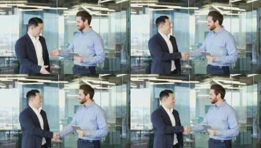两个人握手，商务人士在办公室会面成功交易高清在线视频素材下载