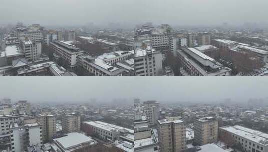 航拍陕西省西安市大雪中的西安钟楼街道风景高清在线视频素材下载