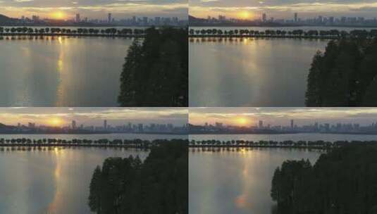 航拍武汉东湖绿道傍晚湖面夕阳候鸟飞翔高清在线视频素材下载