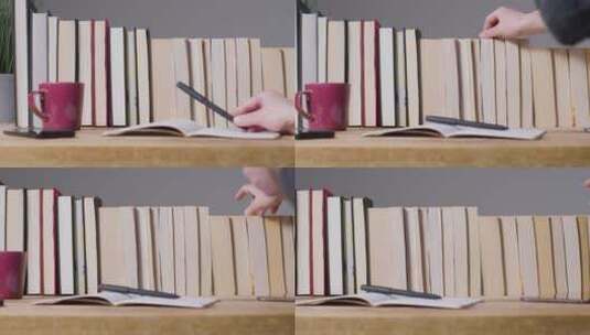 女人在书房放下笔并从书架上选择一本书籍高清在线视频素材下载