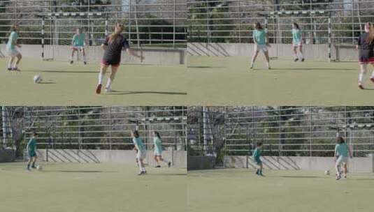 女运动员在露天球场踢足球高清在线视频素材下载