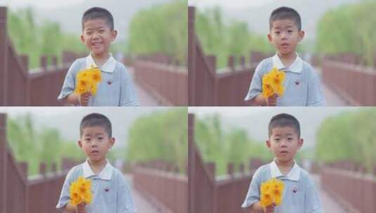 小朋友拿着鲜花微笑高清在线视频素材下载