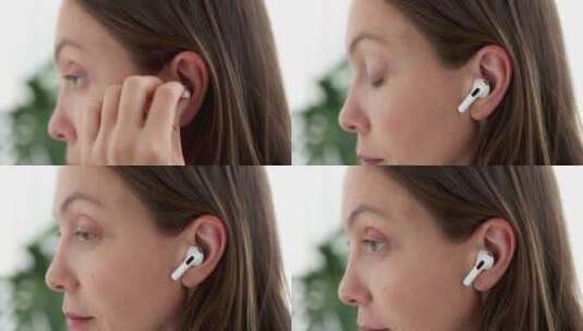 女孩将无线白色耳机插入耳朵高清在线视频素材下载