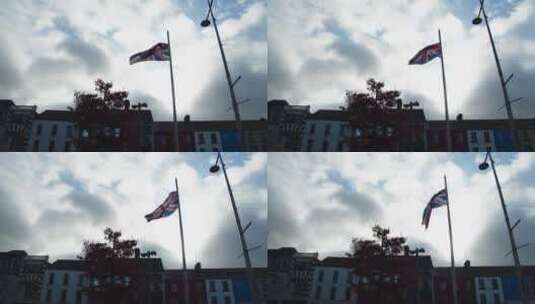 旗杆随风摆动时升起的英国国旗高清在线视频素材下载