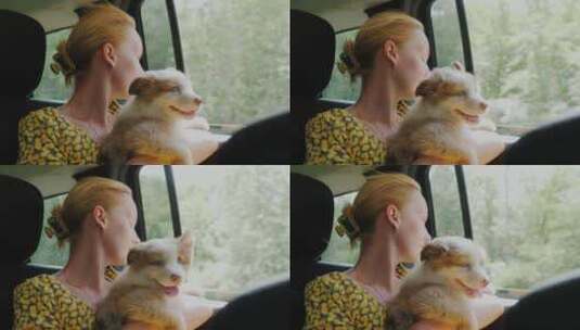 女人坐在车内抱着宠物狗高清在线视频素材下载