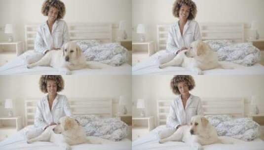 女人和她的狗在床上休息高清在线视频素材下载