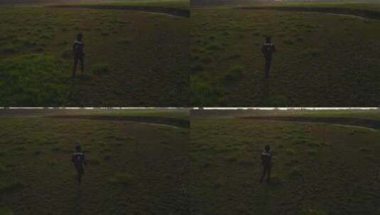 草地上奔跑的男人高清在线视频素材下载