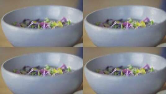 从碗中拿出紫色花朵高清在线视频素材下载