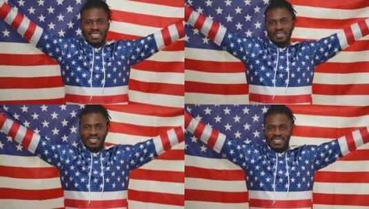 快乐的非裔美国人骄傲的人伸手拿着美国国旗看着相机微笑高清在线视频素材下载