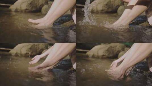 年轻的女性在水里洗脚高清在线视频素材下载