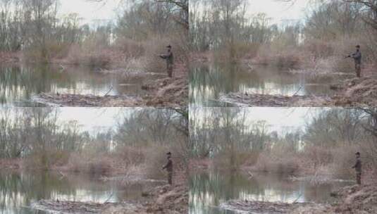 男子站在湖边钓鱼高清在线视频素材下载