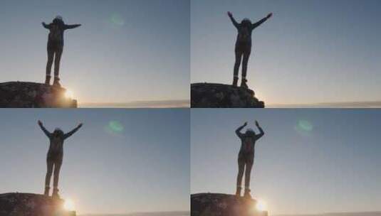 一位成功的女旅行者在山顶举起双手庆祝到达山顶高清在线视频素材下载