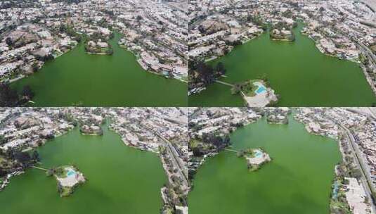 一个绿色的湖泊和湖边的房子高清在线视频素材下载