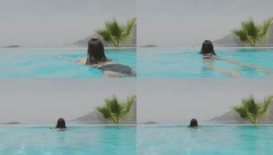 女人在高级度假酒店无边泳池游泳高清在线视频素材下载