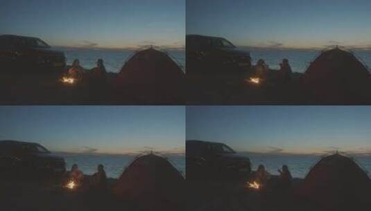 一对情侣夜晚在海边搭帐篷露营高清在线视频素材下载