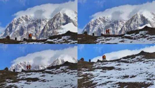 航拍垭口观看贡嘎山区雪山群峰的徒步旅行者高清在线视频素材下载