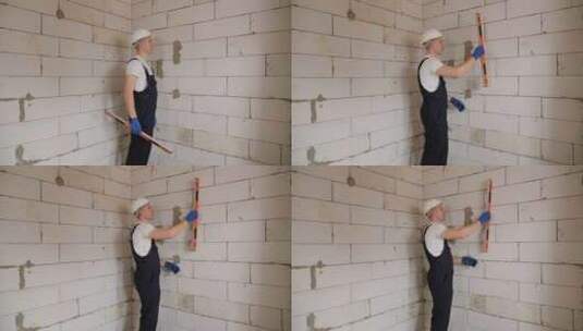 一名戴白色头盔的男性建筑工人在建筑工地上高清在线视频素材下载